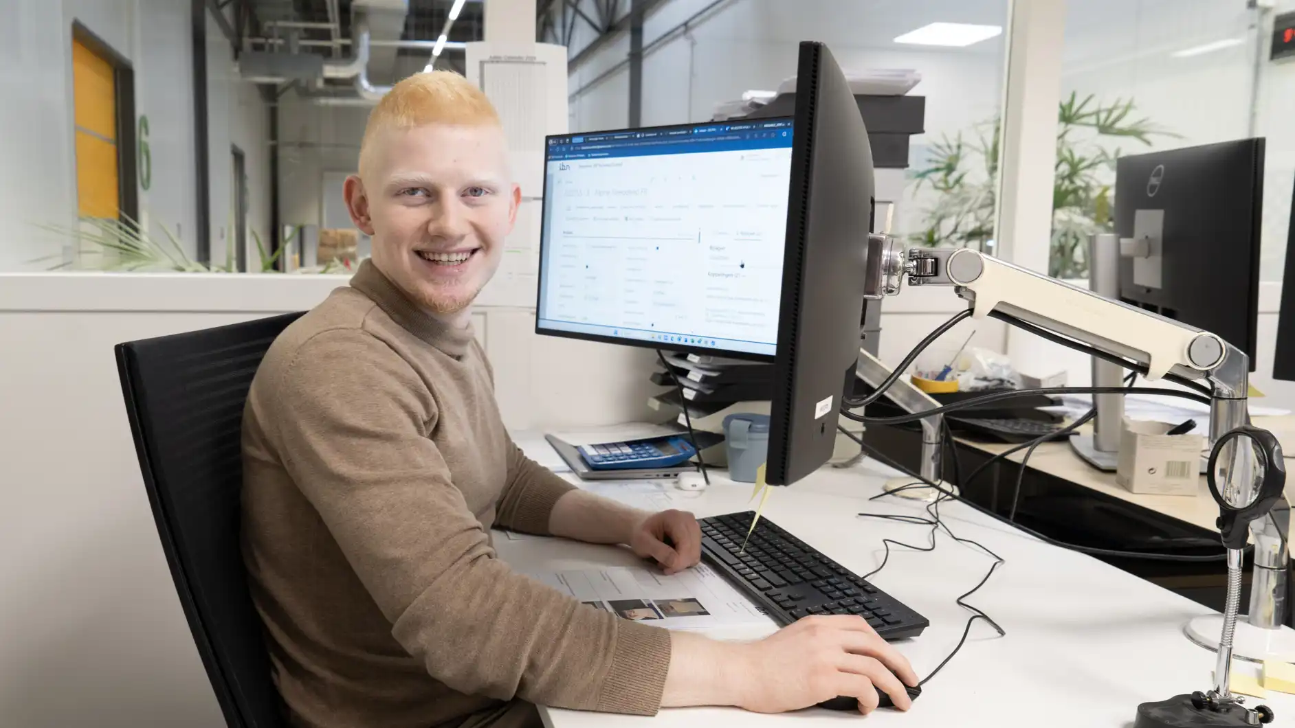 Hasan op zijn werkplek achter de computer